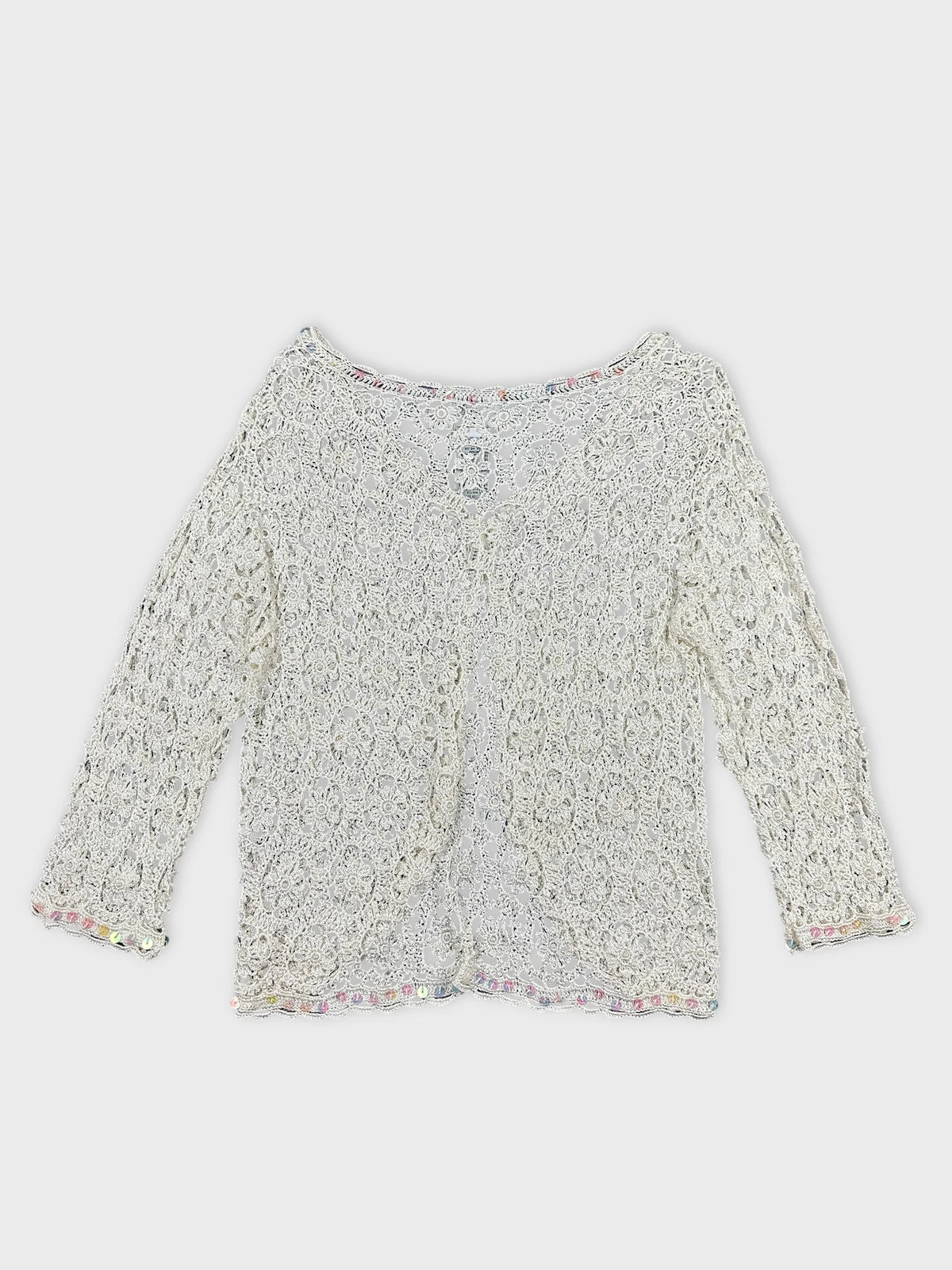 Back view of a white long sleeve top with lace pattern and trim.