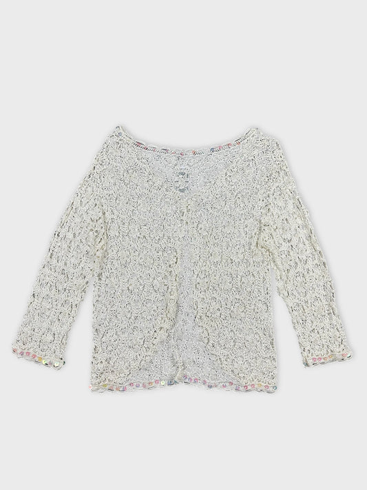 Back view of a white long sleeve top with lace pattern and trim.
