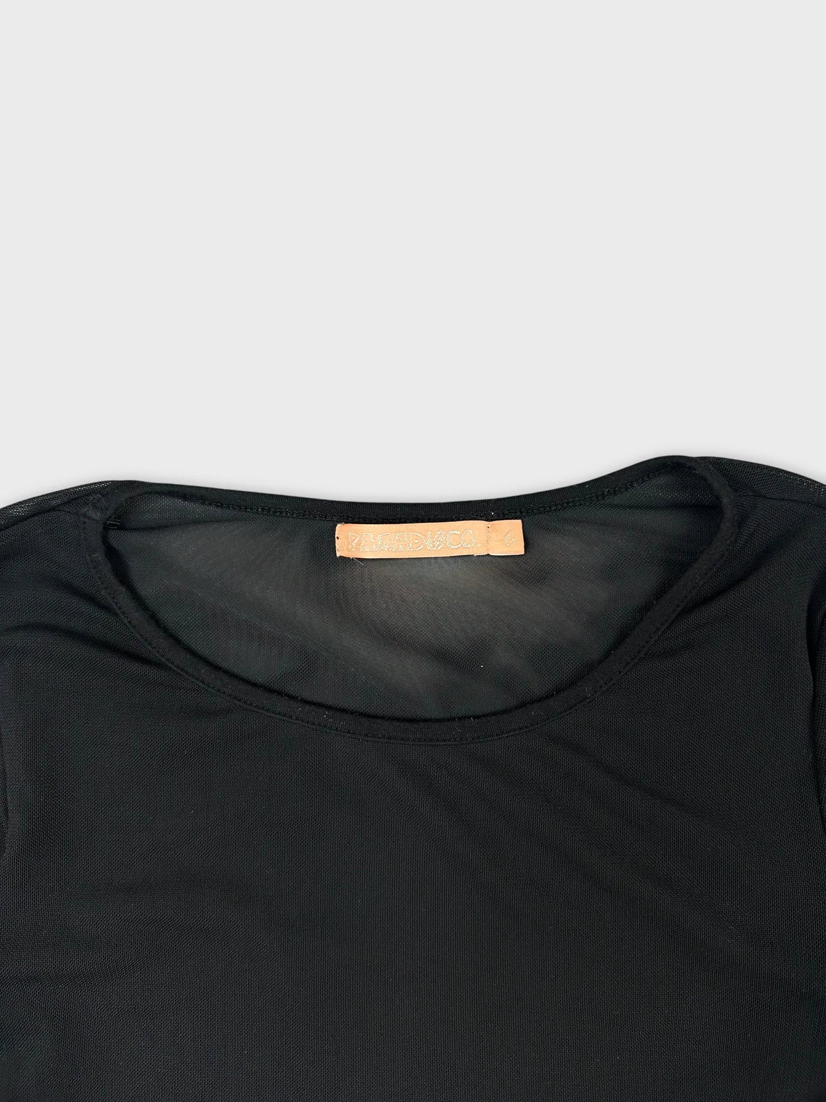 Black long sleeve top with round neckline detail view