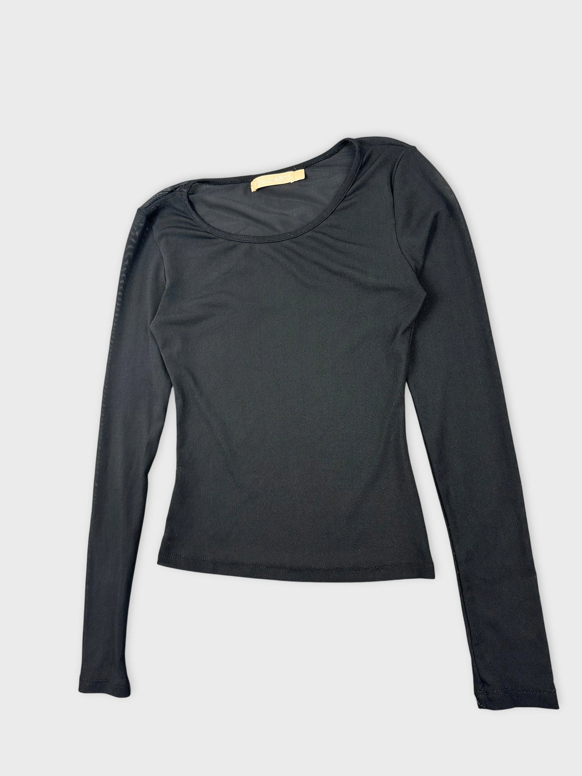 Detail view of a long sleeve top in black with a round neckline.