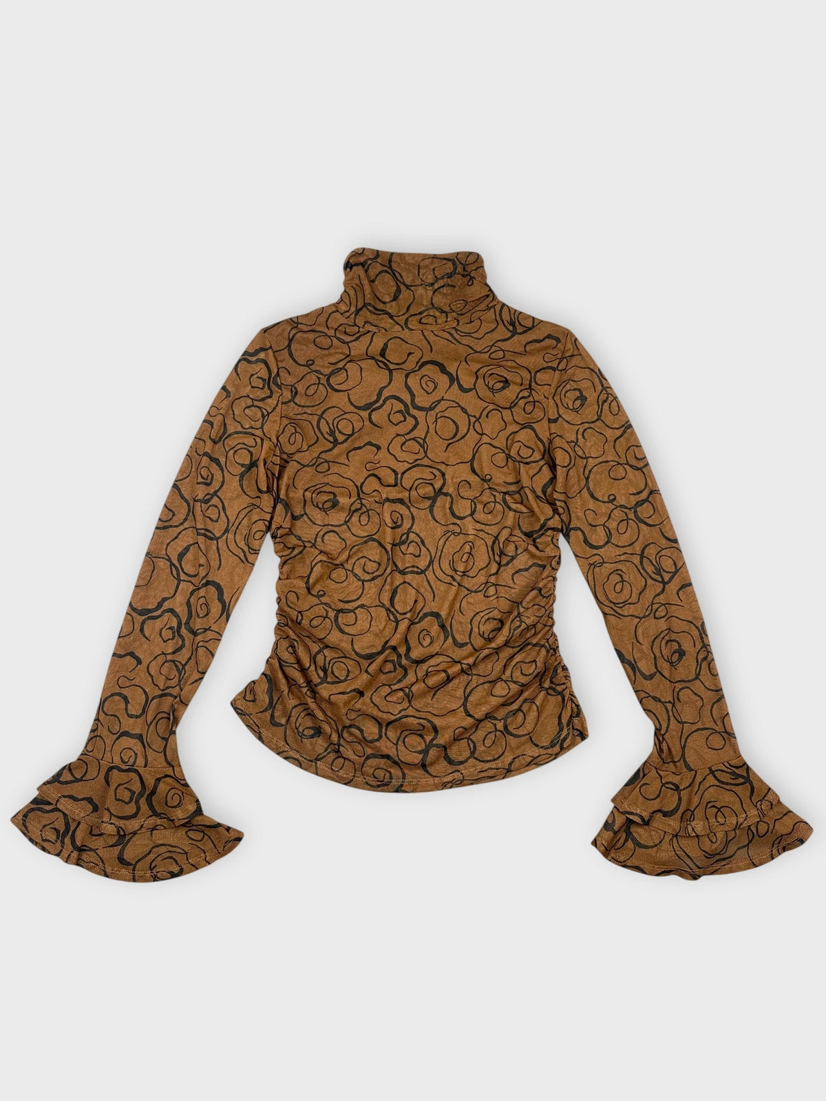 Front view of a brown long sleeve top with black floral patterns.