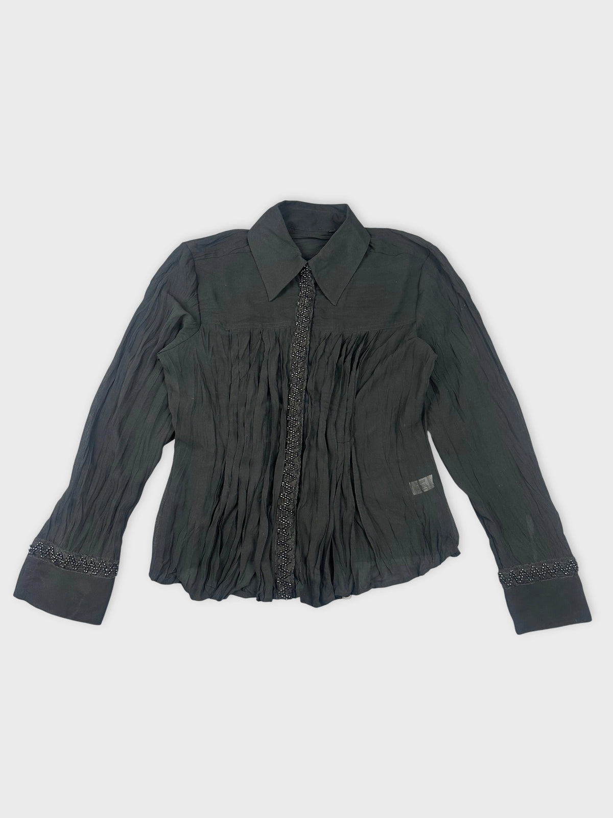 Black long sleeve top with pleated detail front view.