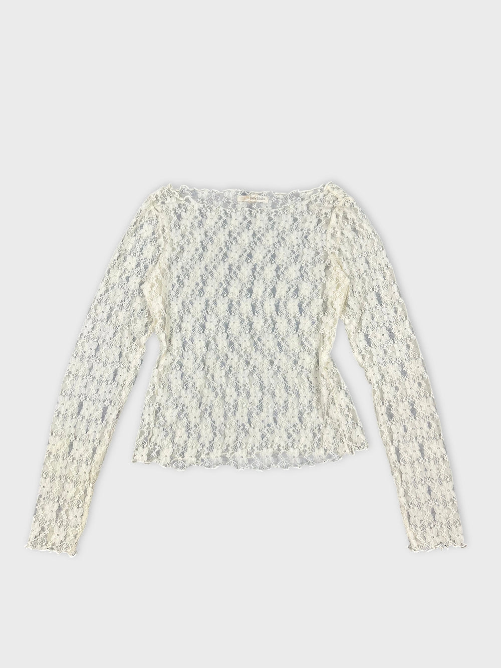 Women's long sleeve top in off-white with lace detail front view.