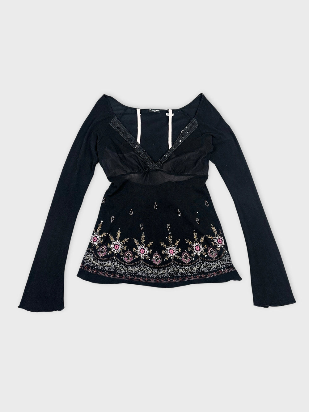 Front view of a black long sleeve top with floral embroidery