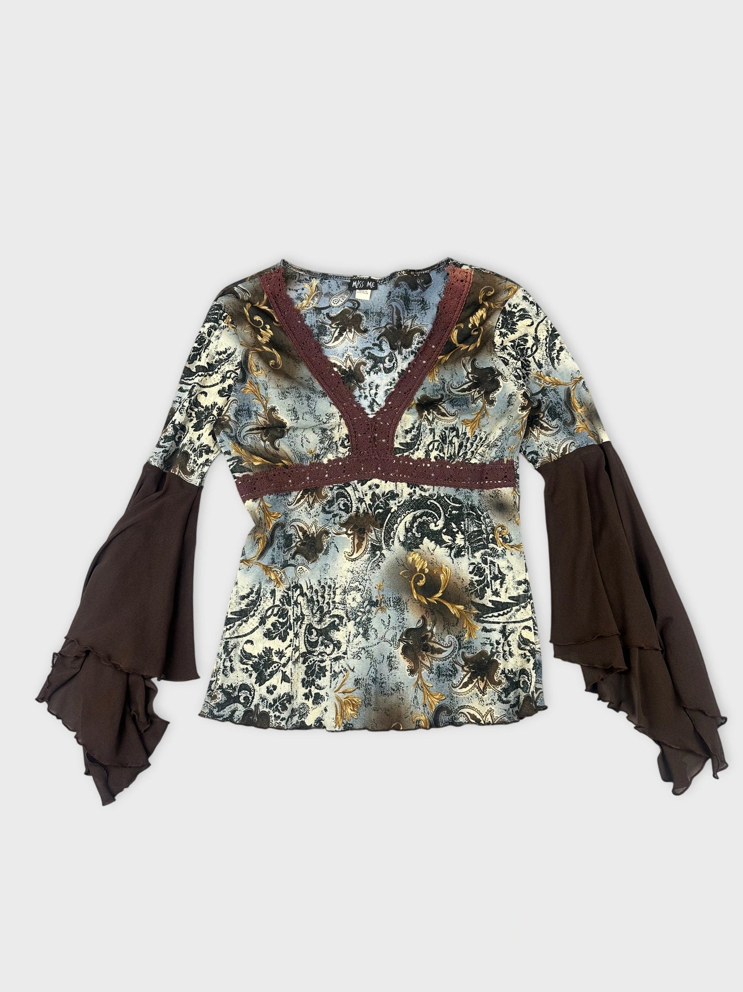 Front view of a vintage long sleeve top in black with floral pattern and ruffled sleeves.