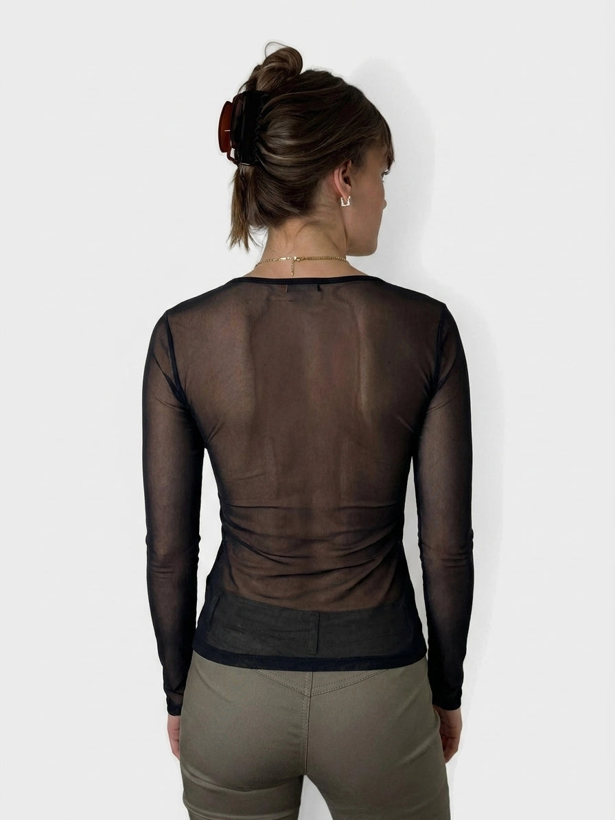 Back view of a women's long sleeve top in sheer black with fitted shape.