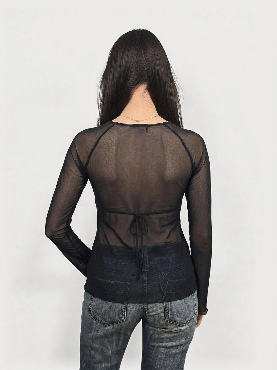 Back view of a black long sleeve top with a tie detail.