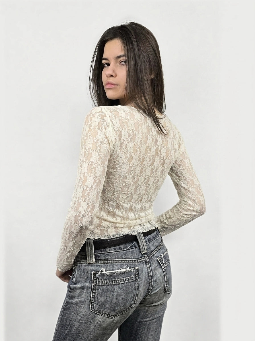Back view of a long sleeve cream lace top with ribbed texture.