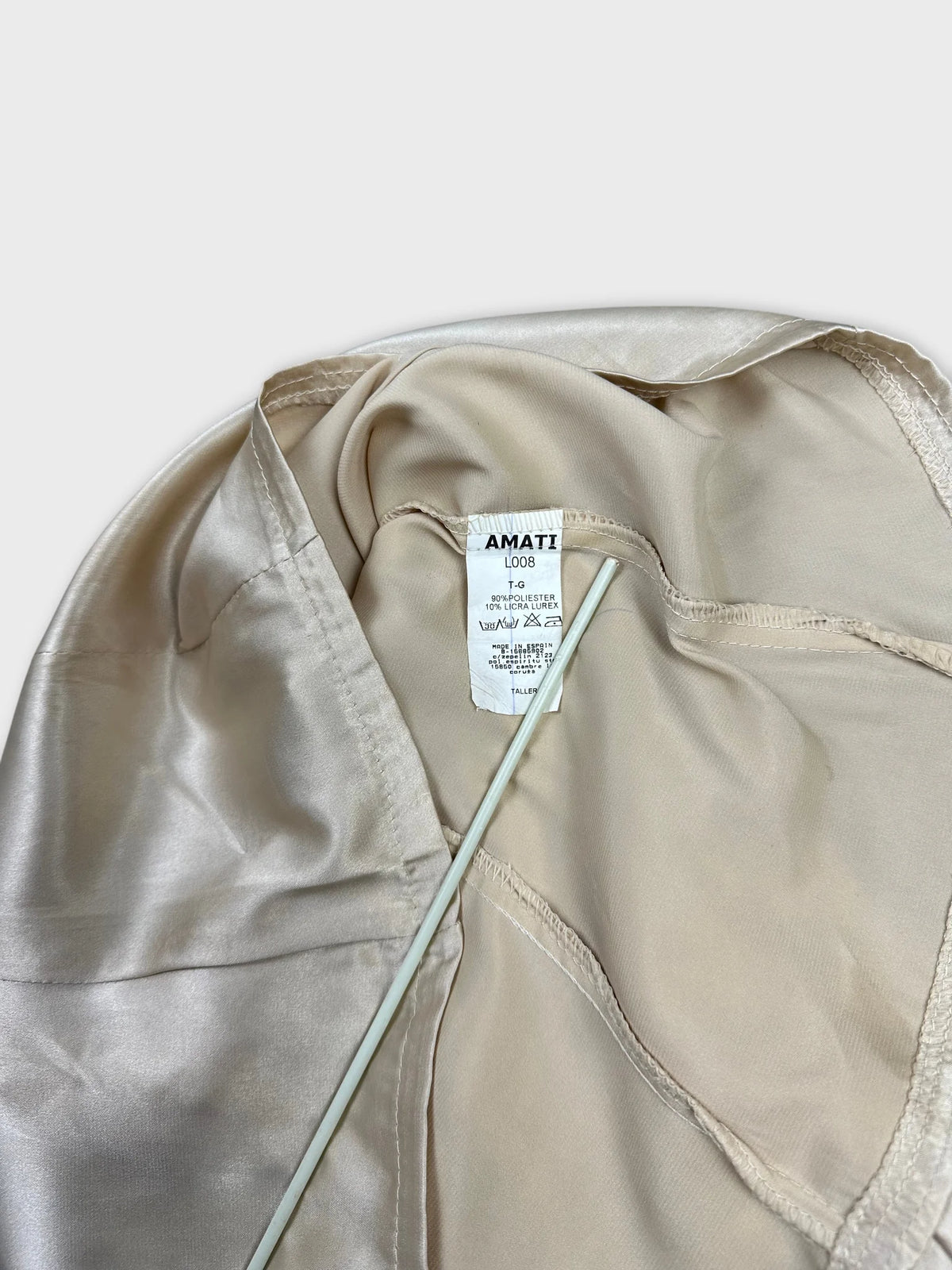 Back view of a short sleeve button-up shirt in light beige with smooth texture