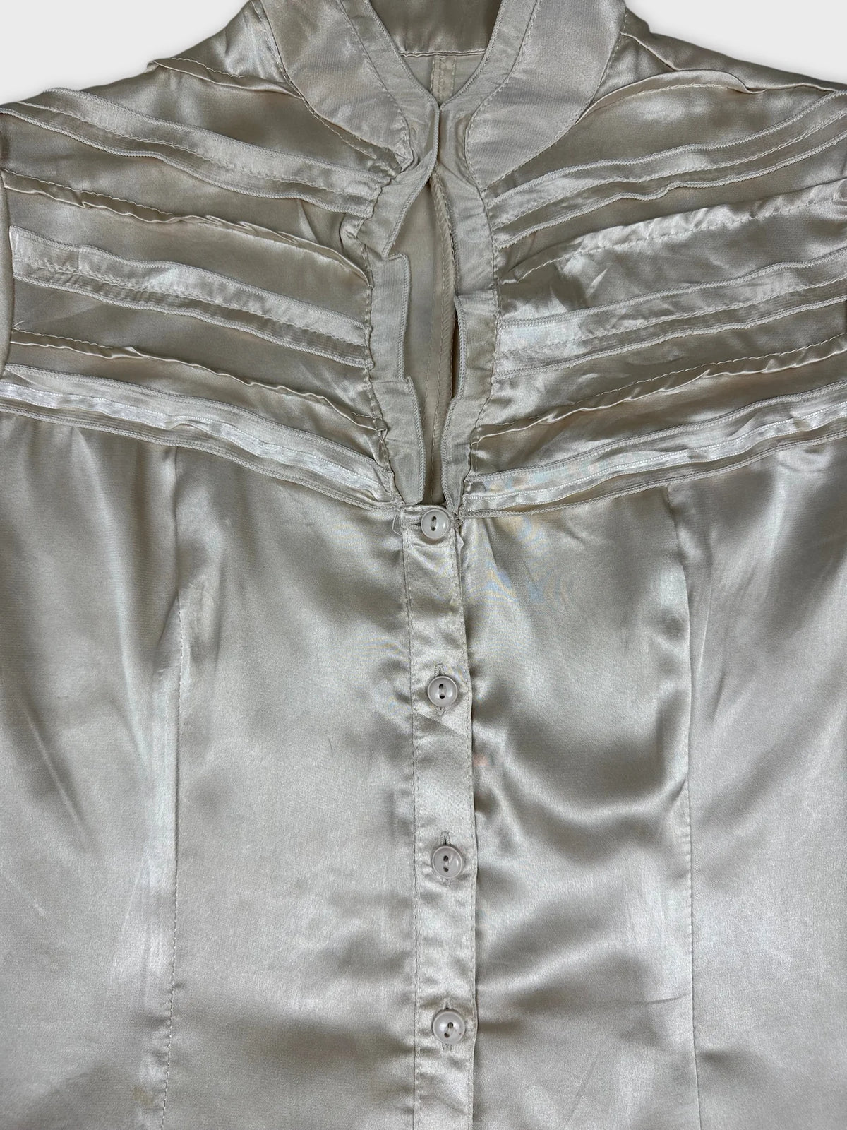 Detail view of a women's short sleeve button up shirt in light silver.