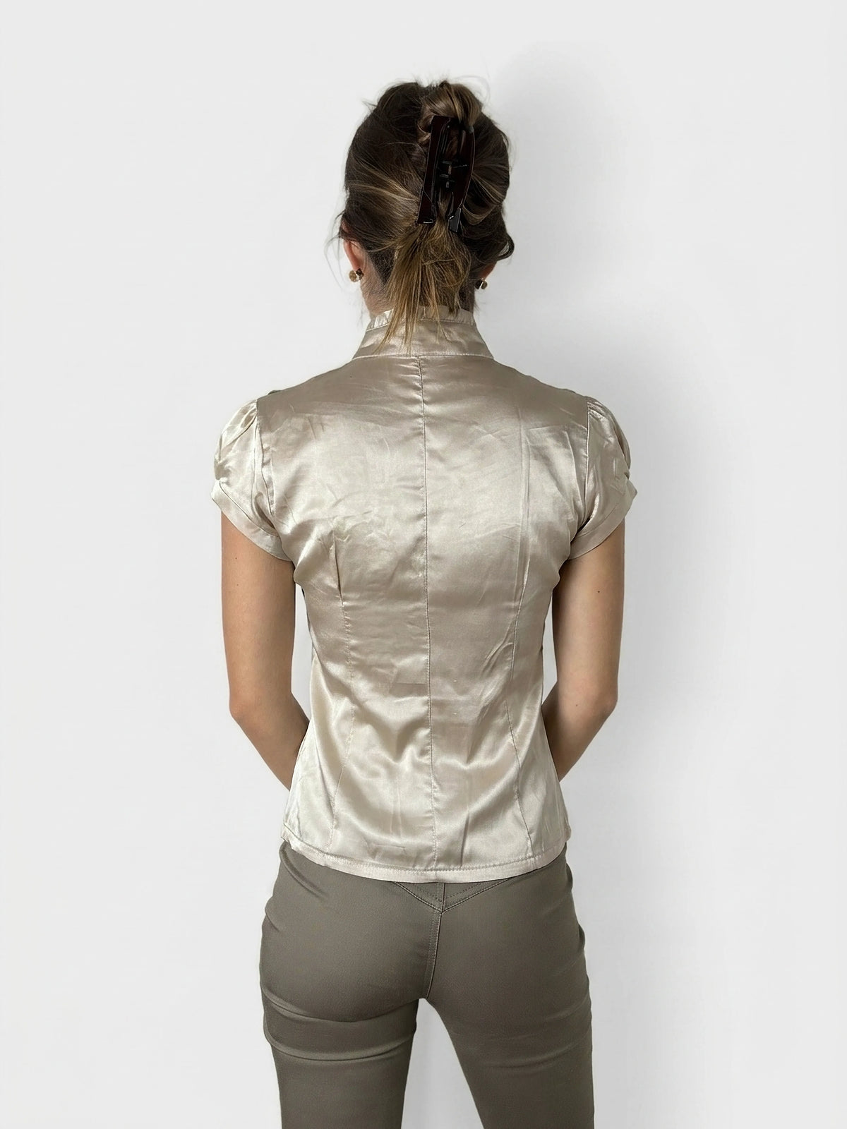 Back view of a short sleeve button-up shirt in beige with a fitted shape.