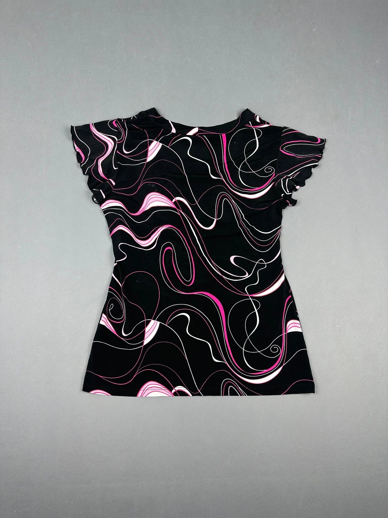 Back view of a short sleeve shirt in black with pink swirl patterns.