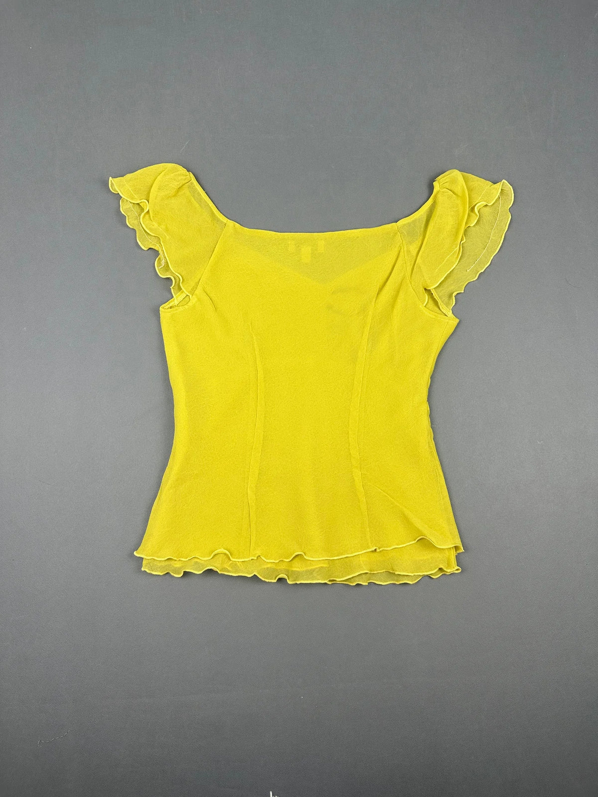 Back view of a yellow short sleeve top with ruffled sleeves.