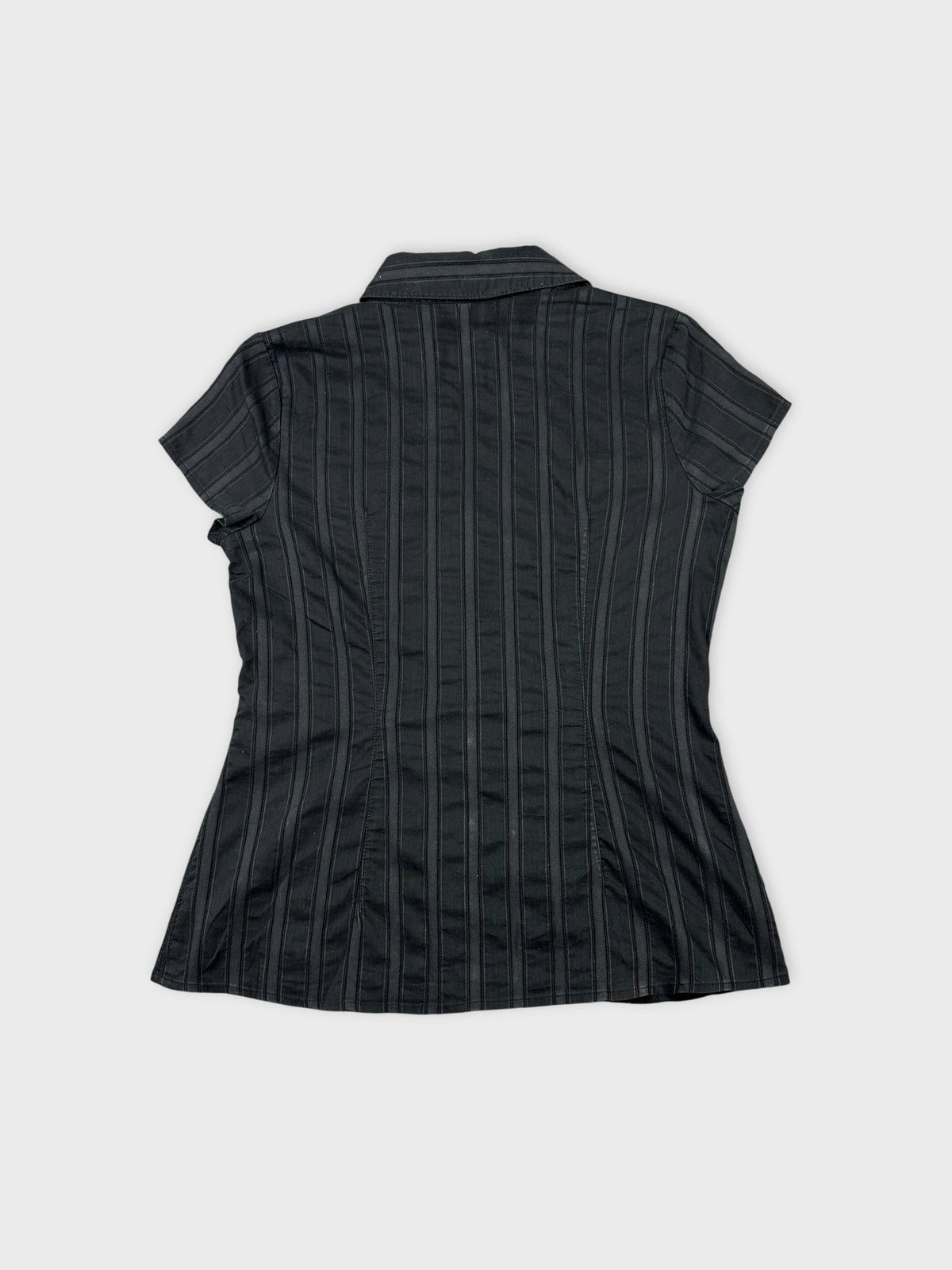 Back view of a black short sleeve shirt with vertical stripes.