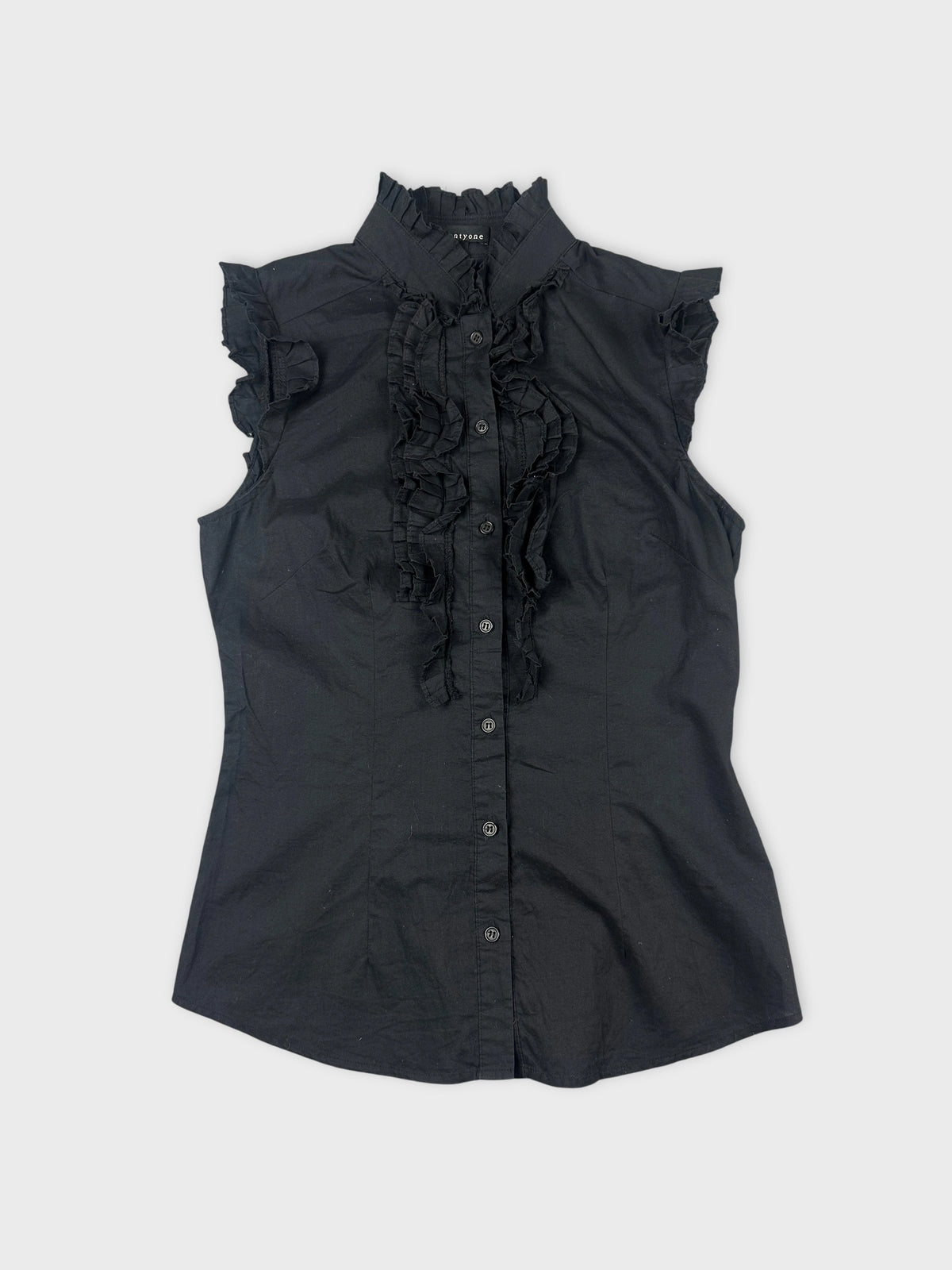 Front view of a black short sleeve shirt with ruffled detailing.