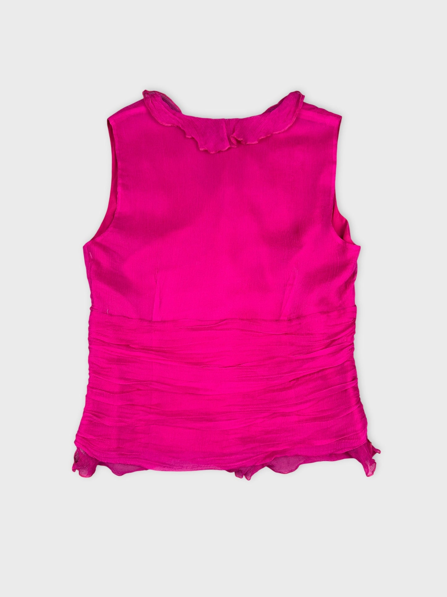 Back view of a sleeveless bright pink top with frilled neckline