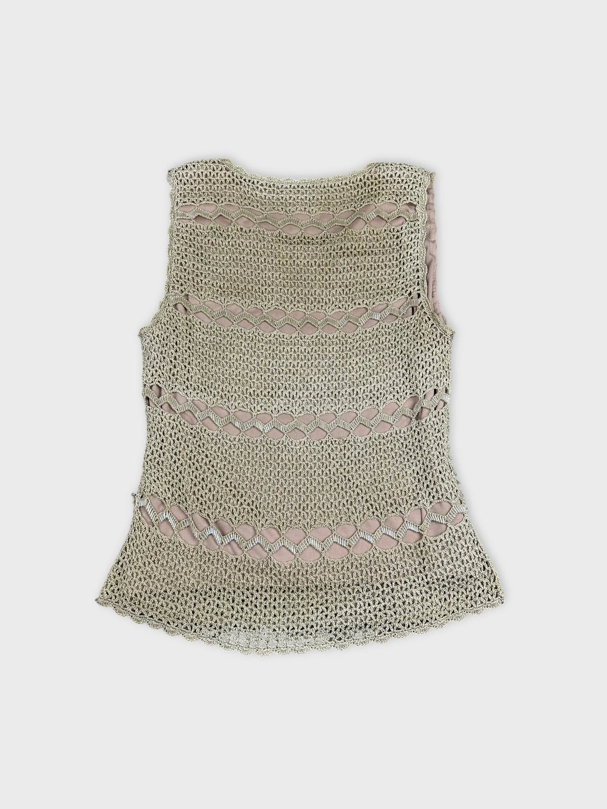 Back view of a crochet top in cream with cut-out detailing.