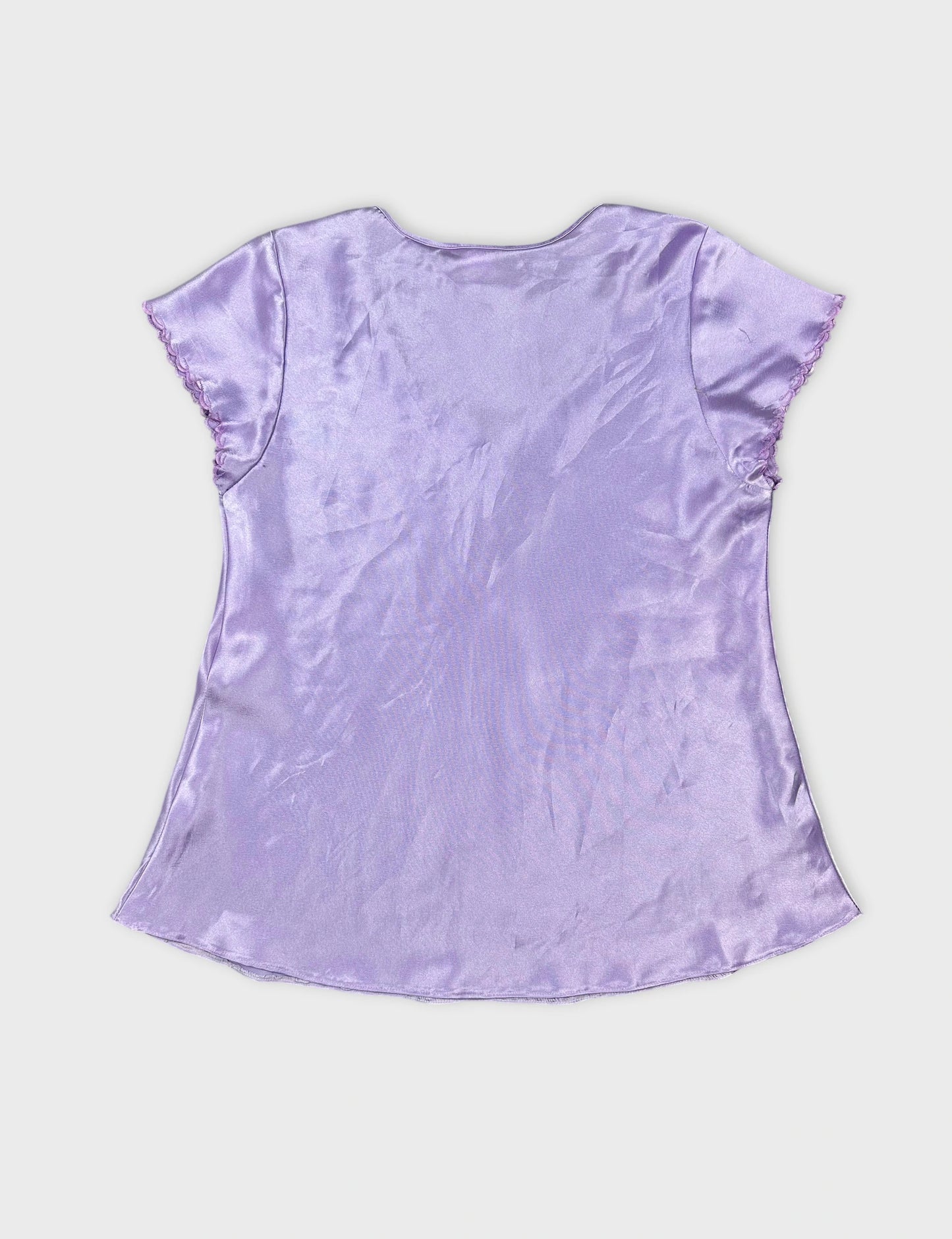 Back view of a light purple short sleeve top with scalloped trim.