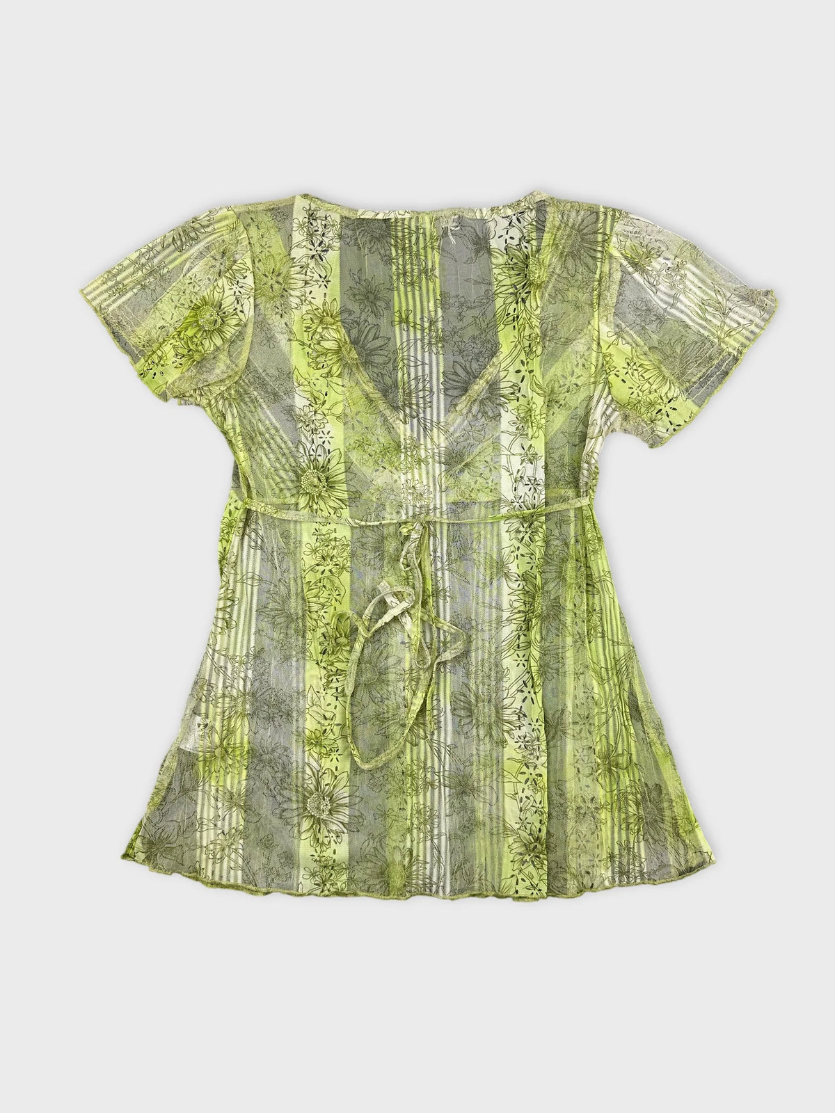 Back view of a short sleeve top featuring a green floral pattern.