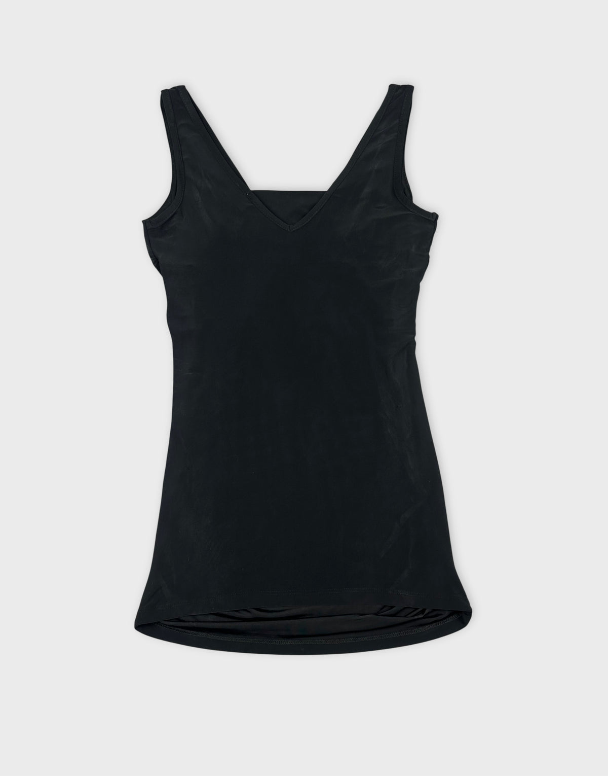 Black sleeveless top with a V-neck in back view.