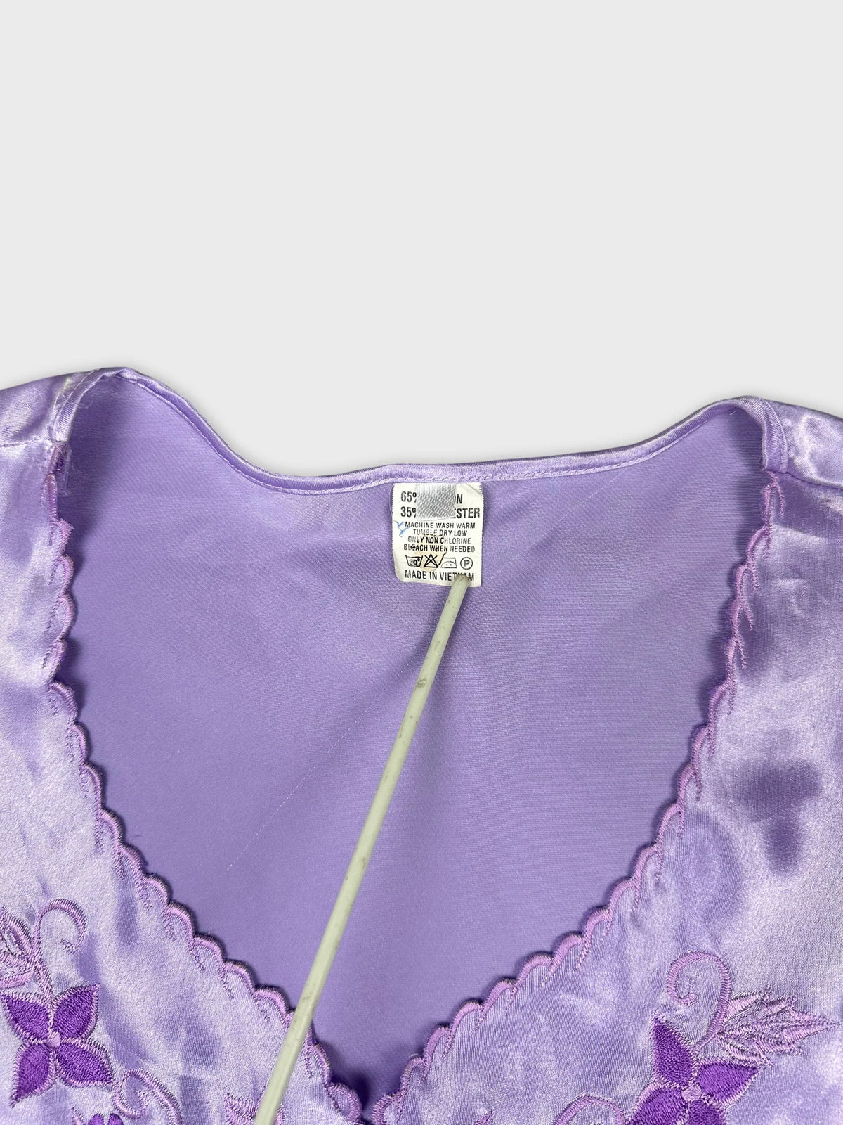 detail view of women's short sleeve top in lavender with floral embroidery
