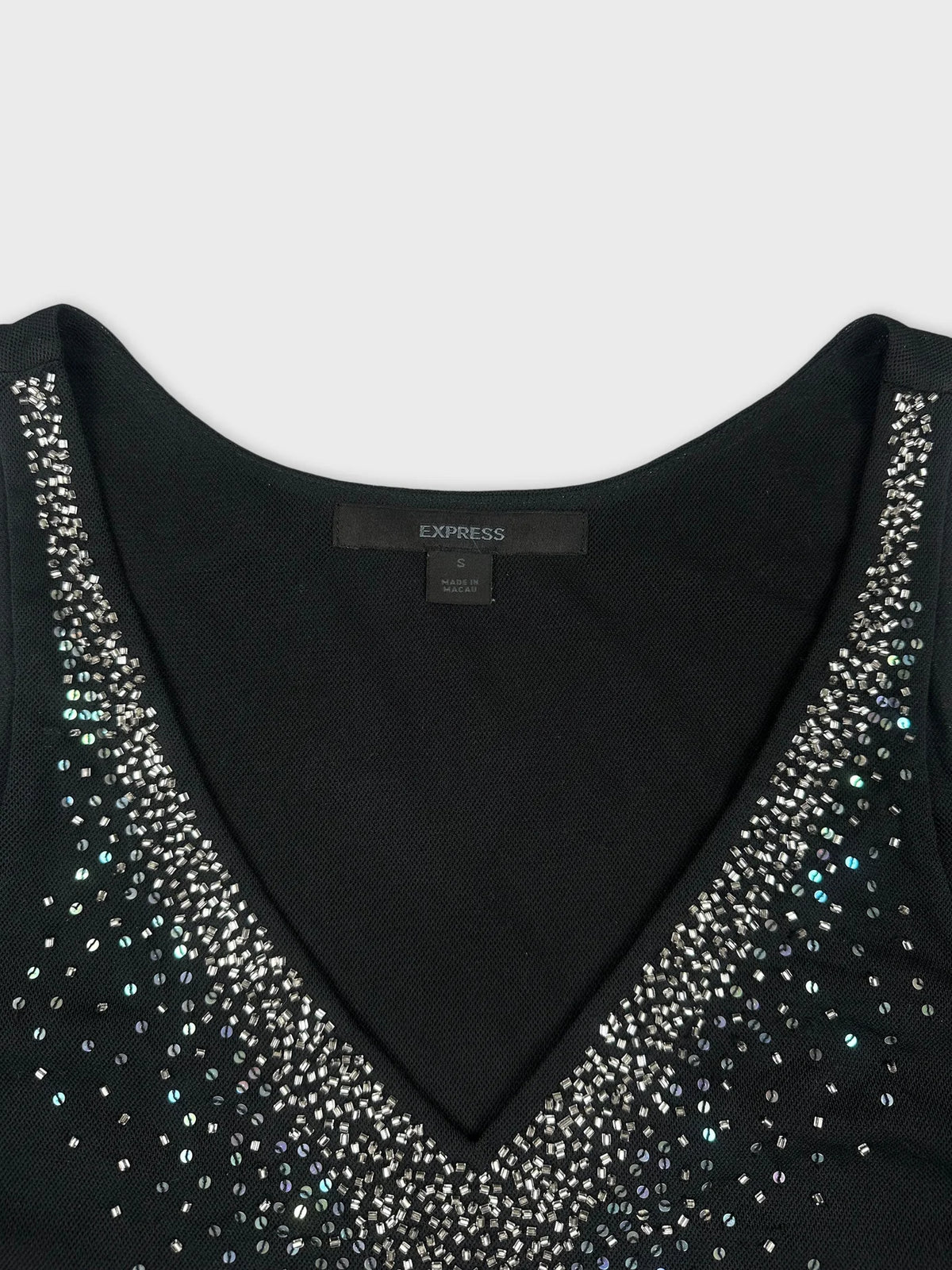 Black top with sparkling beaded detail view from above.