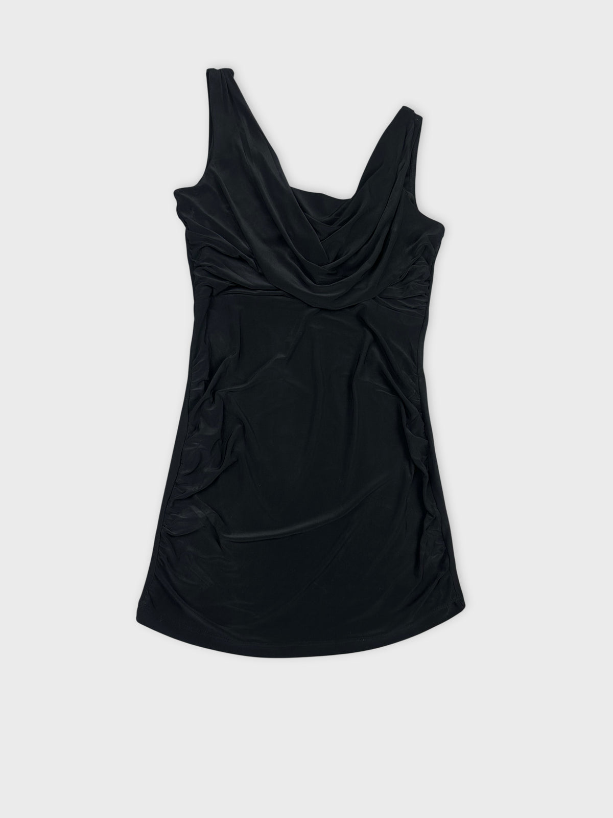 Detail view of a black sleeveless top with draped neckline.