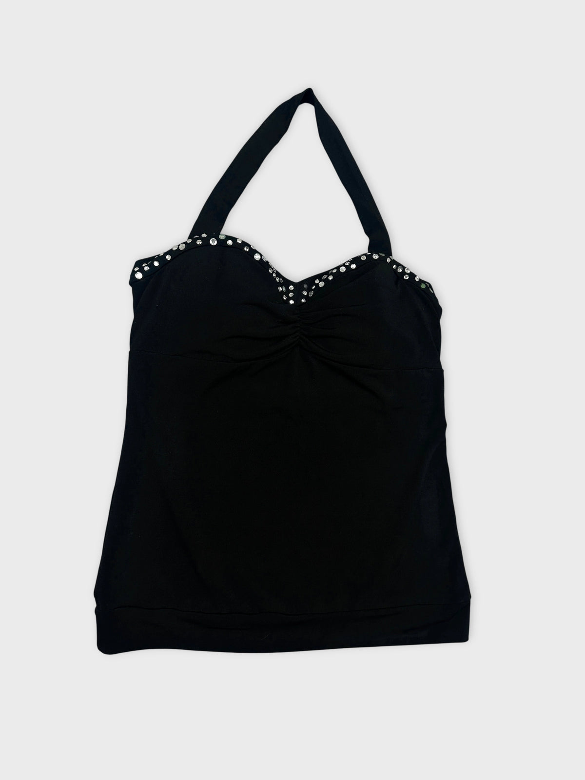 Detail view of a black women’s top featuring a beaded trim.