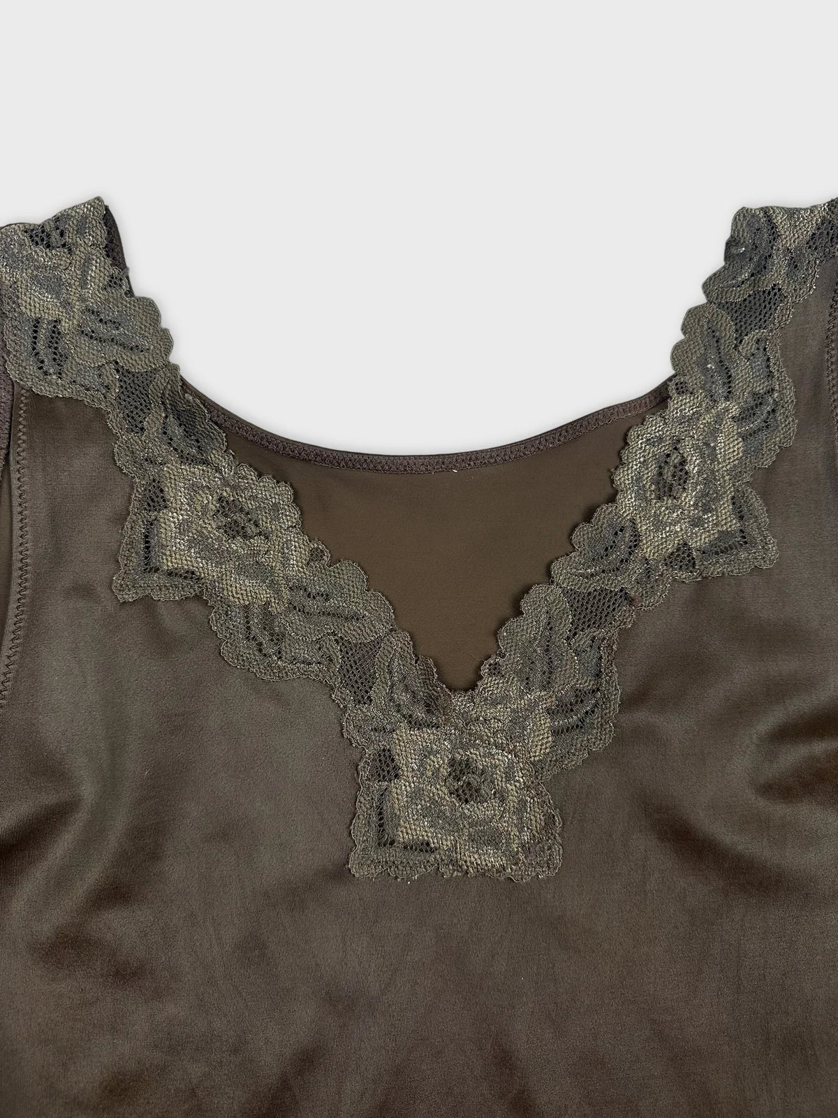 detail view of a vintage short sleeve top in dark brown with lace trim