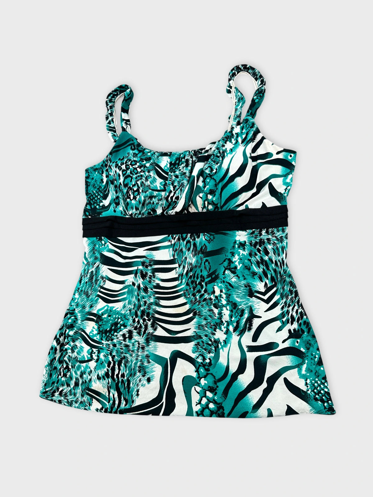 Detail view of a teal women’s top with animal print pattern.