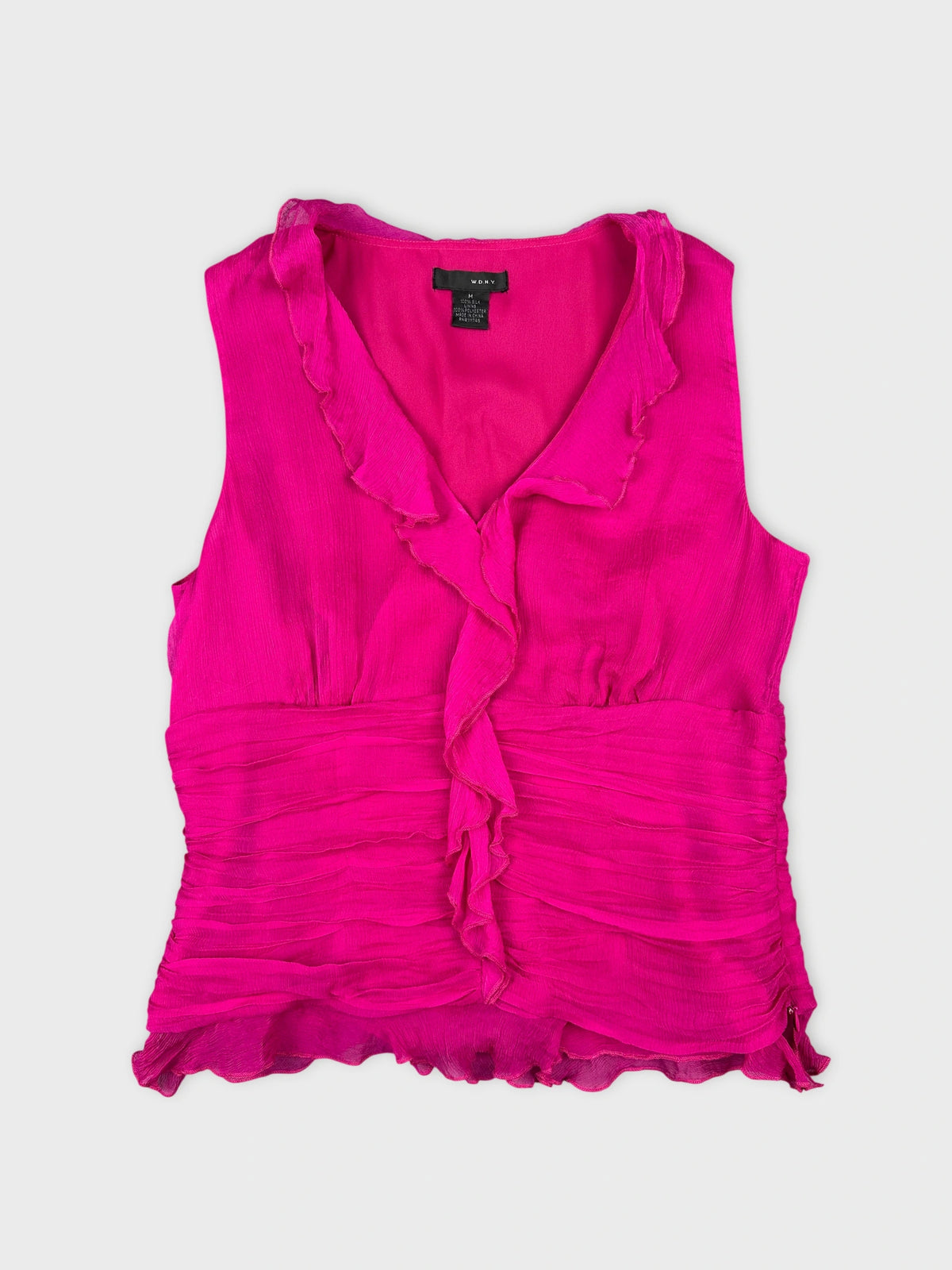 Front view of a vibrant pink sleeveless top with ruffled trim.