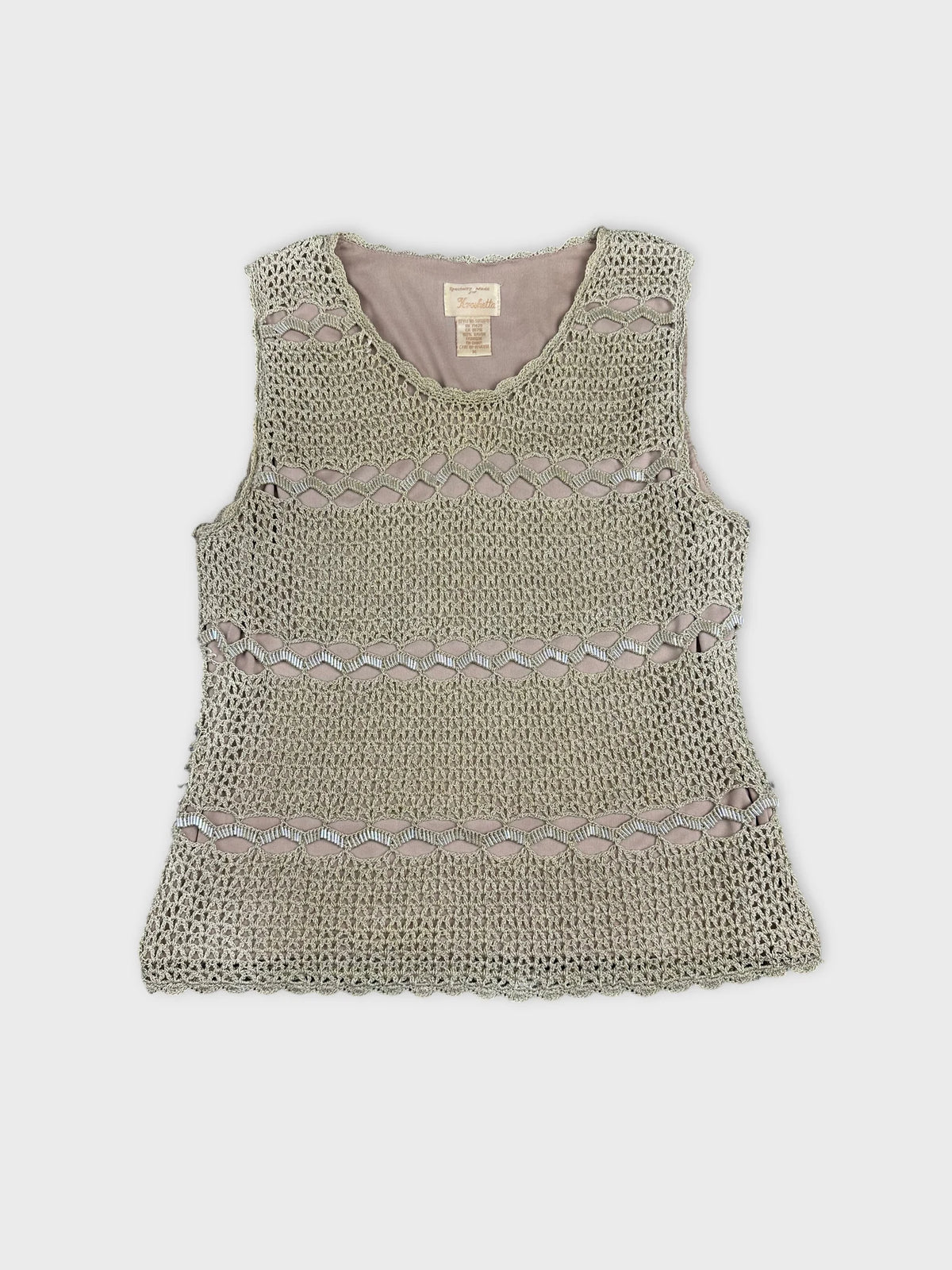 Front view of a vintage short sleeve top in light green with a crochet pattern.
