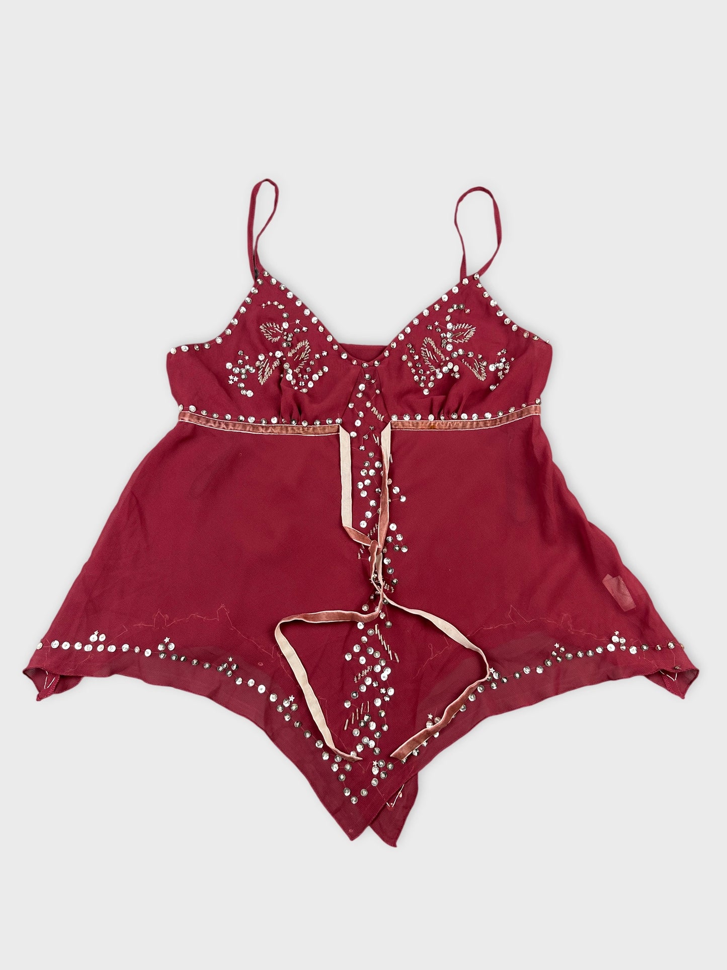 Front view of a burgundy top with silver bead details.