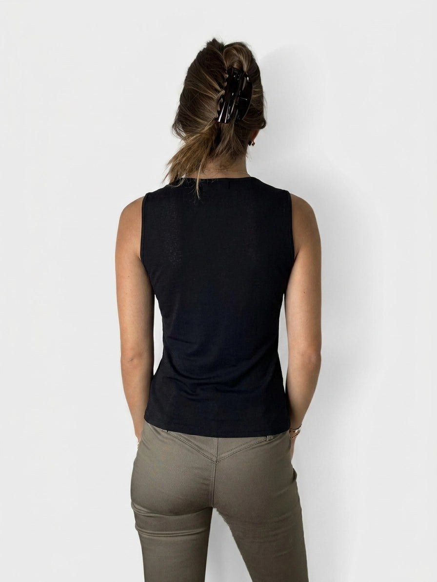 Back view of a black sleeveless top with a round neckline.