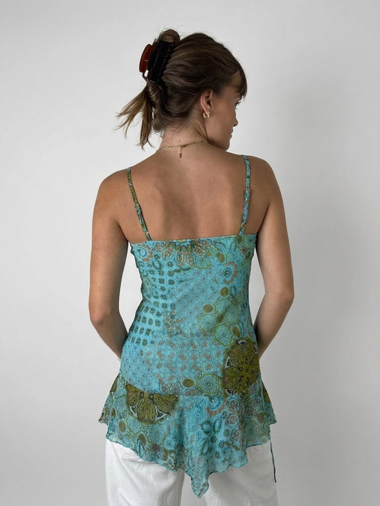 Back view of a turquoise women's sleeveless top with a floral pattern.