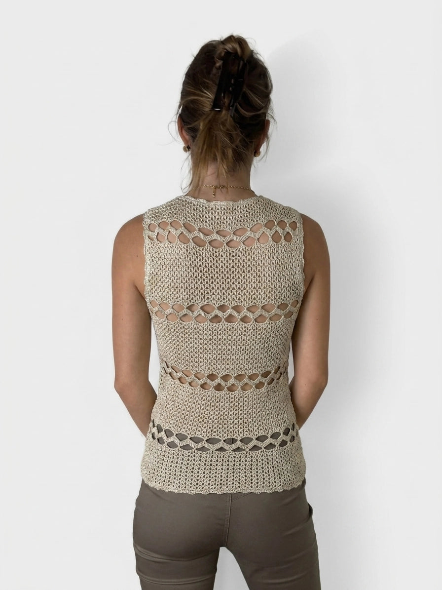 Back view of a beige sleeveless top with open crochet pattern detail.