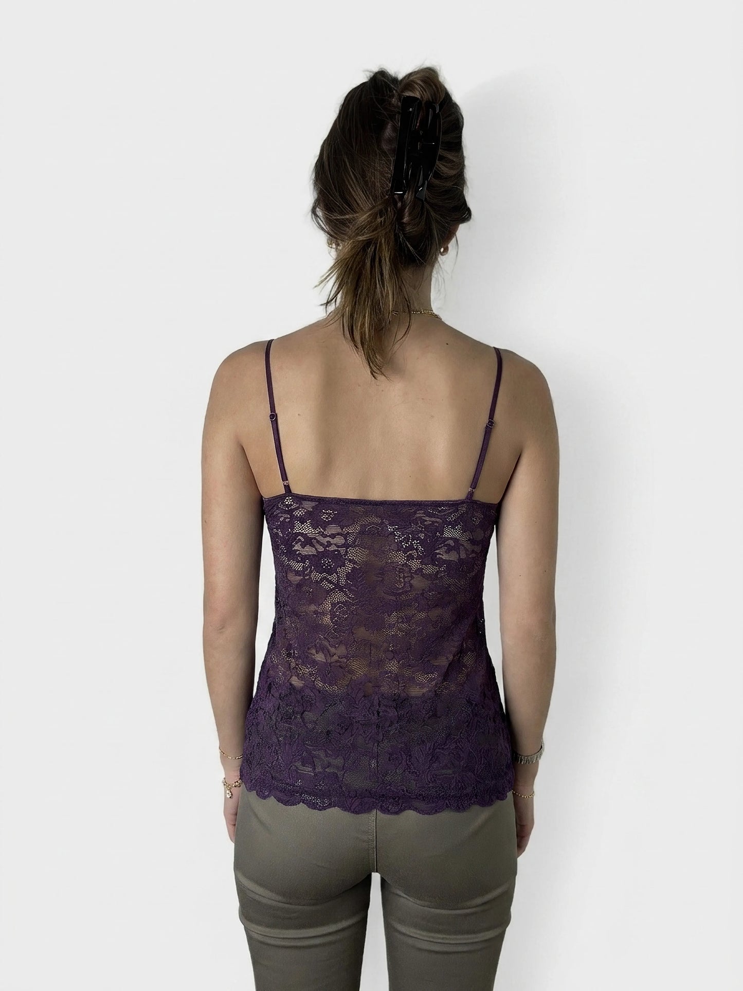 Back view of a purple lace camisole featuring a scalloped hem.
