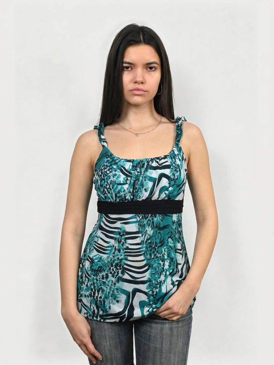 Women’s sleeveless top in teal with a floral print, front view.