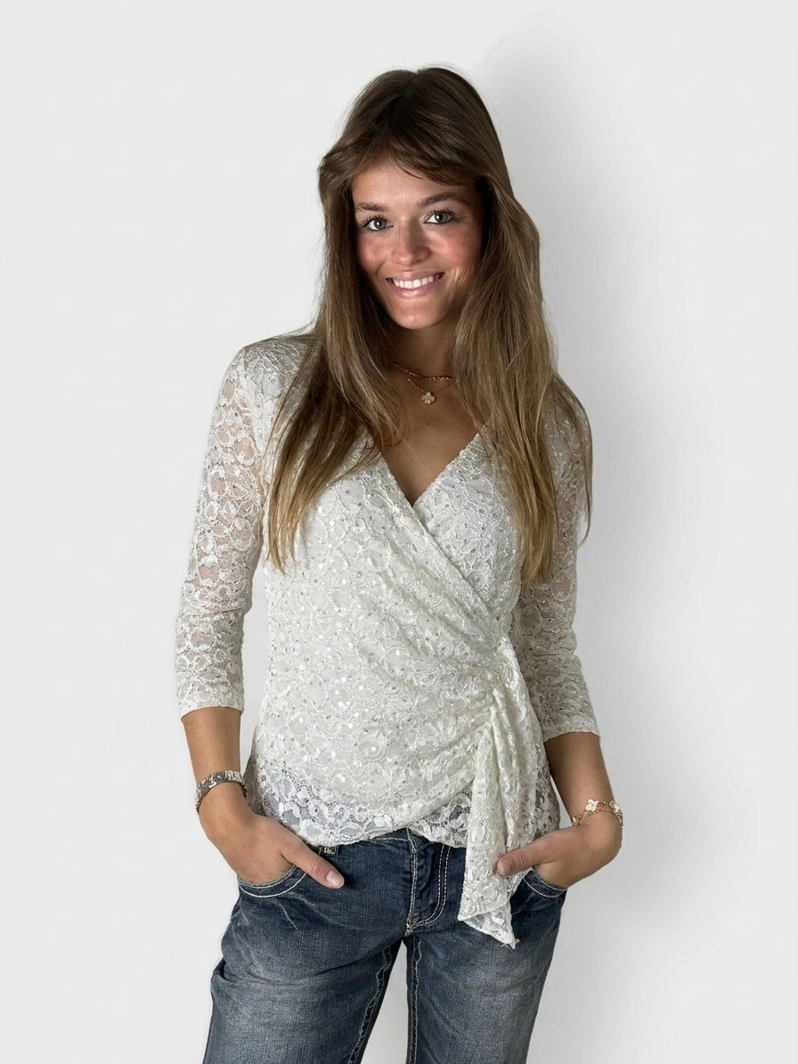 White wrap top with lace detail, shown in front view.