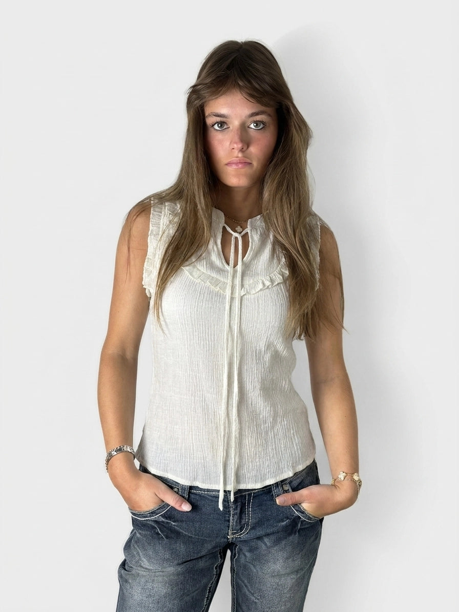 White short sleeve top with ruffled trim, front view.