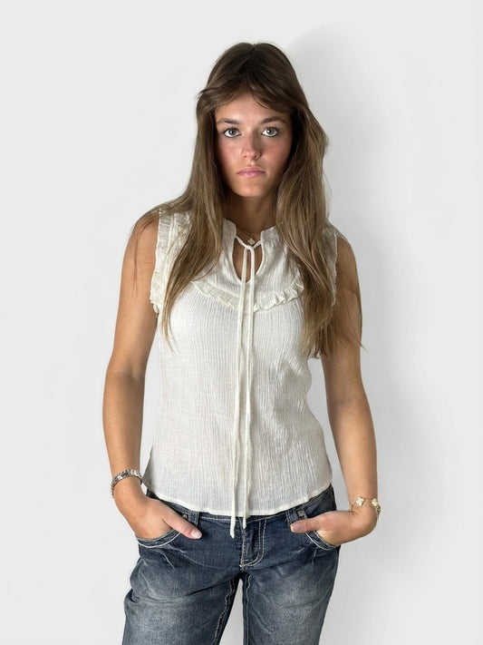 White short sleeve top with ruffled trim, front view.