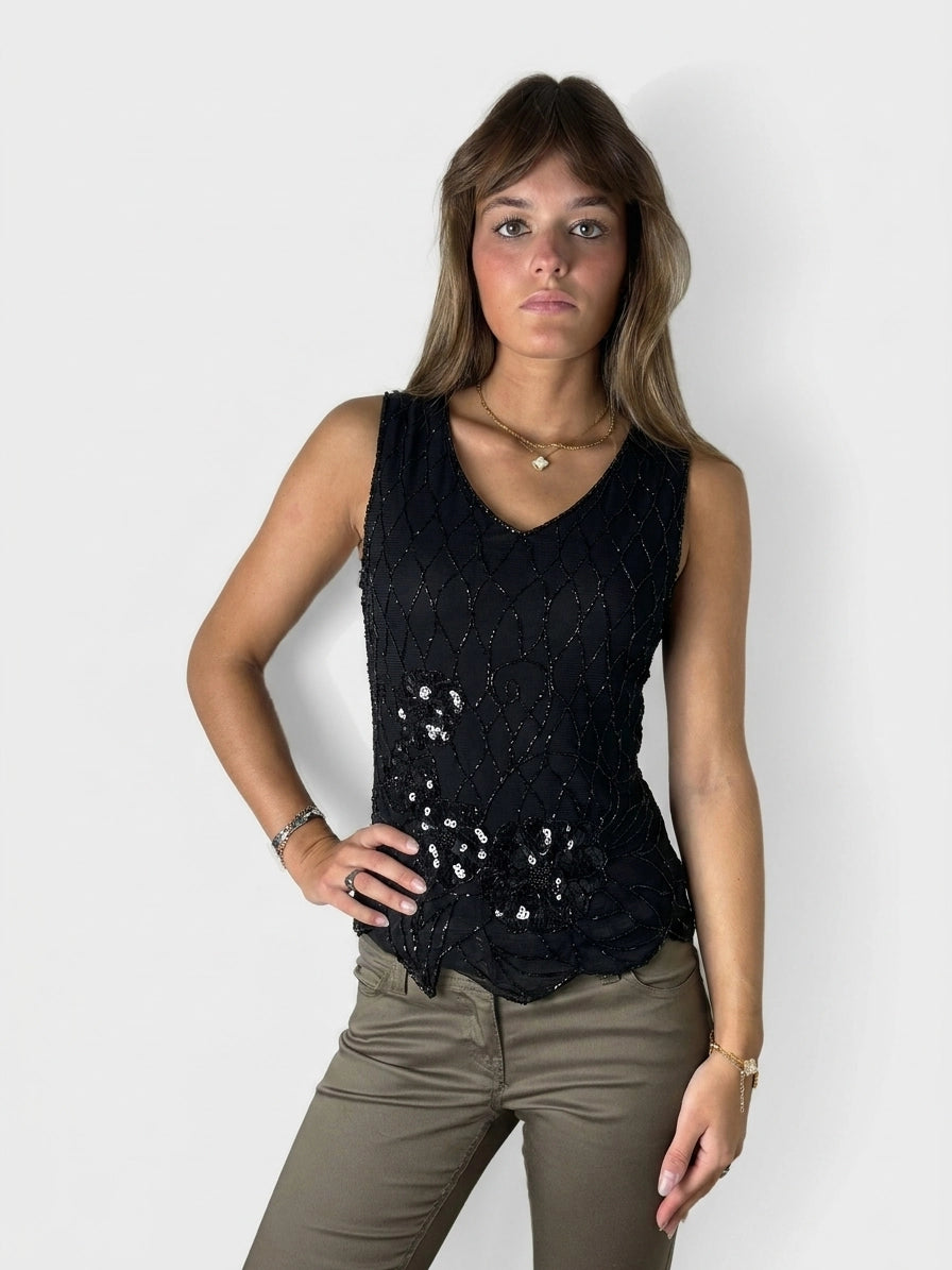 Black sleeveless top with sequin detailing, front view.