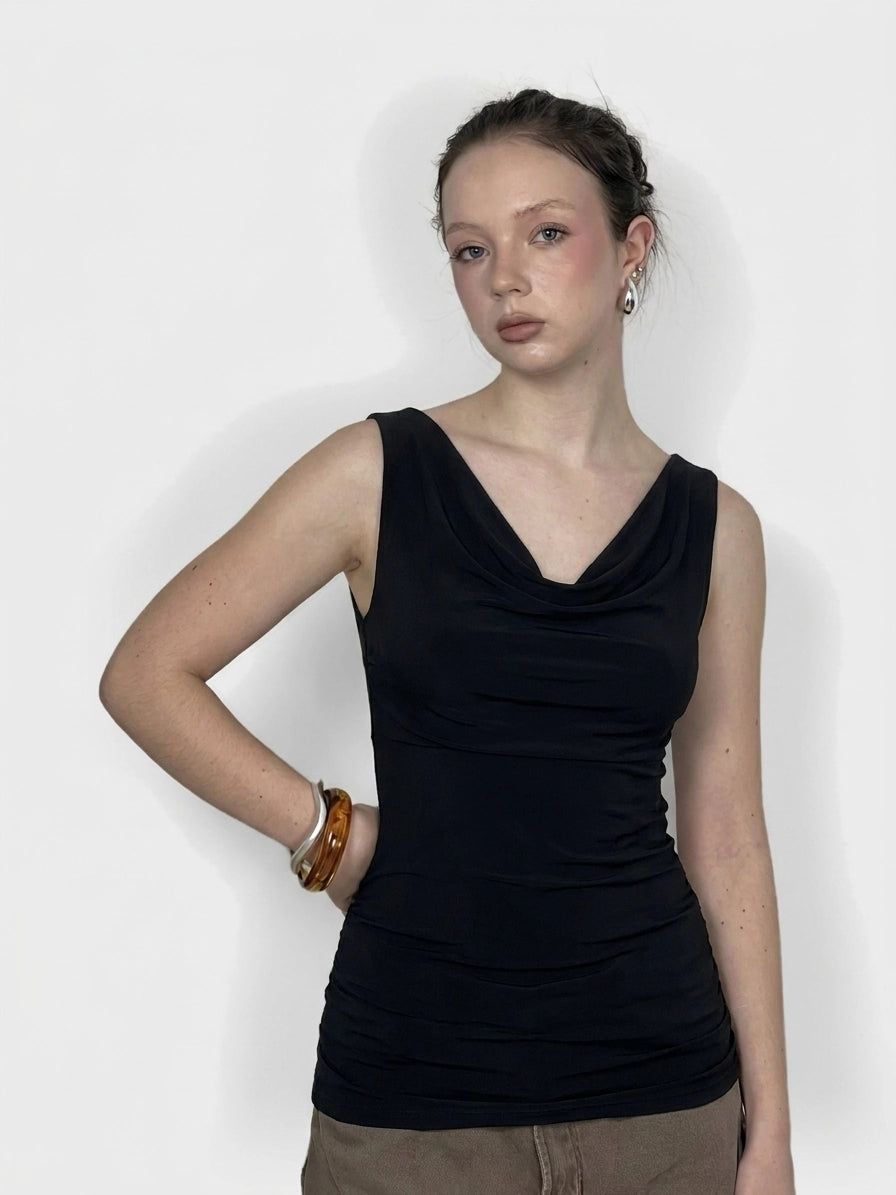 Front view of a black sleeveless top with a draped neckline.