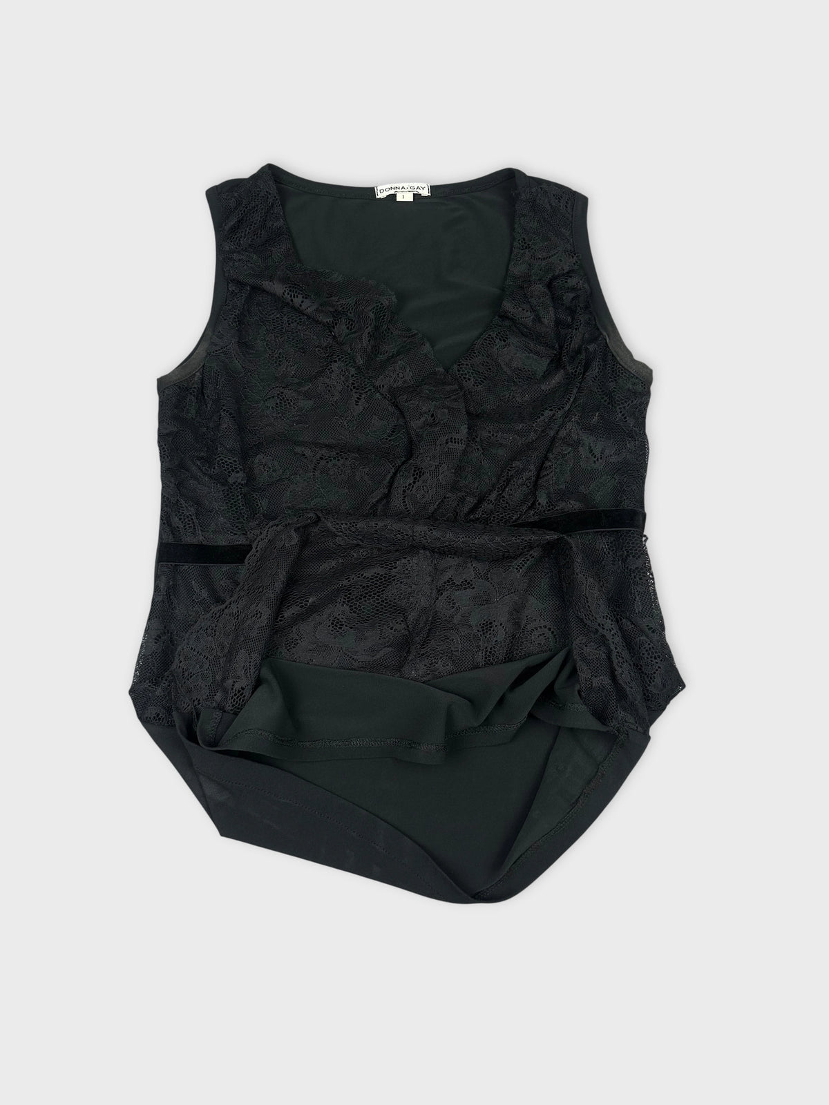 Detail view of a black vintage women’s top featuring lace trim.