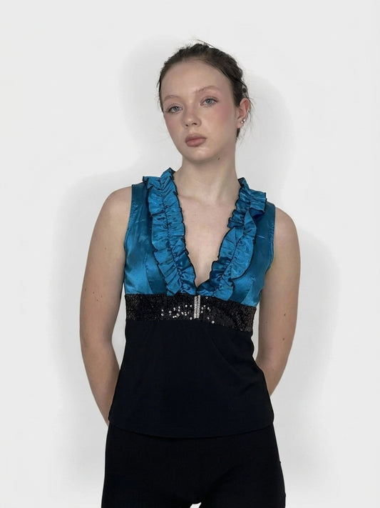 Front view of a teal top featuring ruffled neckline and sequined trim.