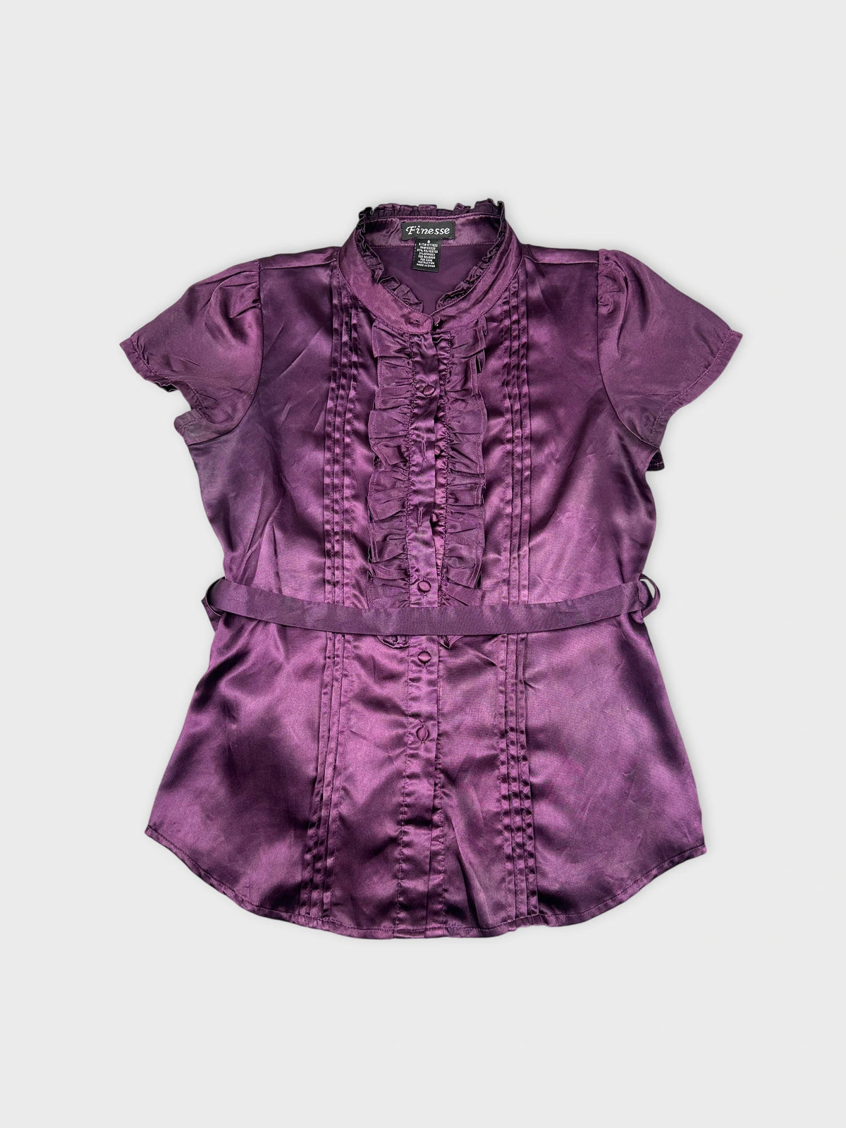 Front view of a purple button-up shirt featuring ruffled trim.