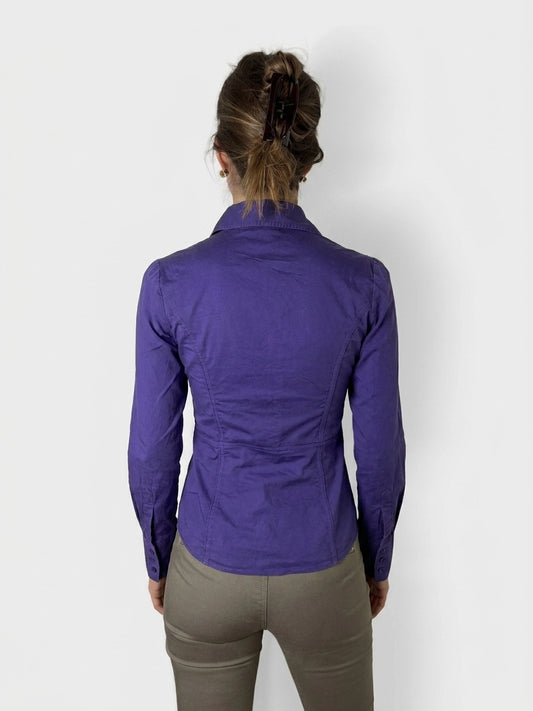Back view of a purple button-up shirt featuring fitted shape and long sleeves.