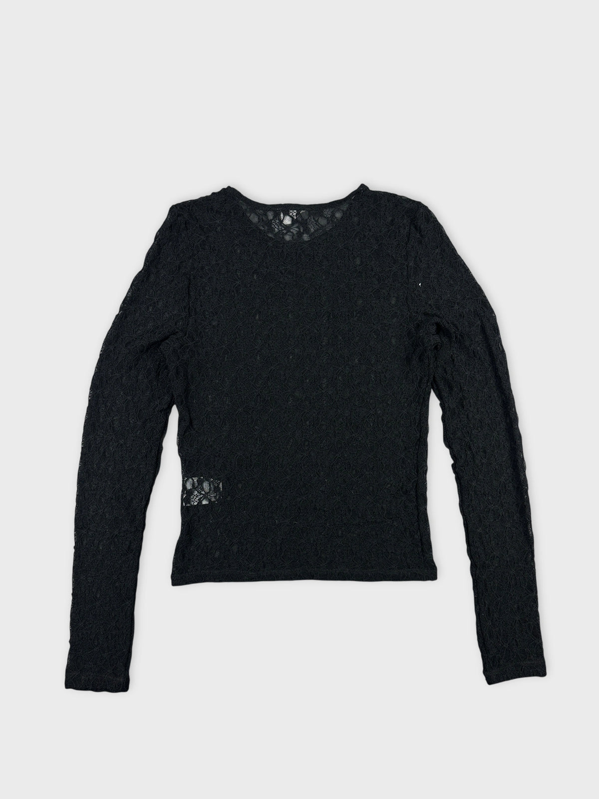 Black long sleeve top with lace pattern back view.