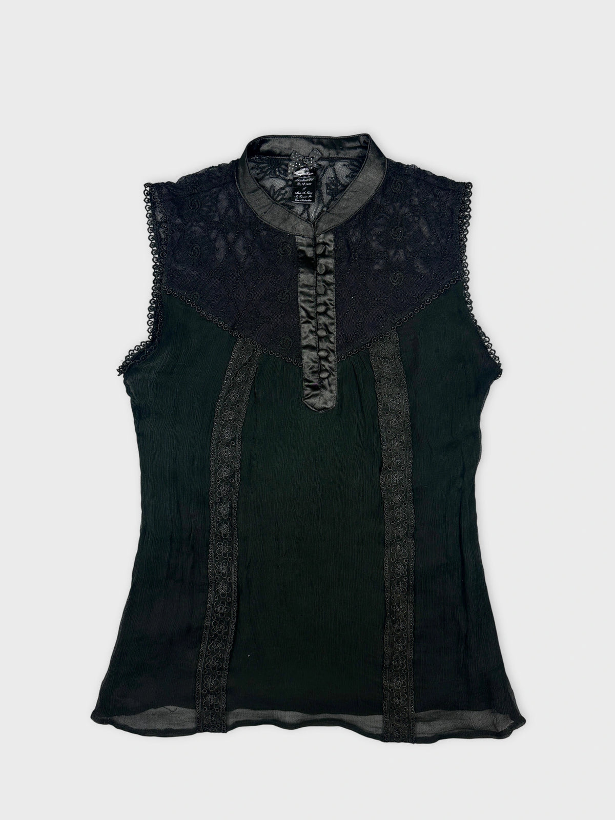 Front view of a black vintage upper body shirt with lace detailing.