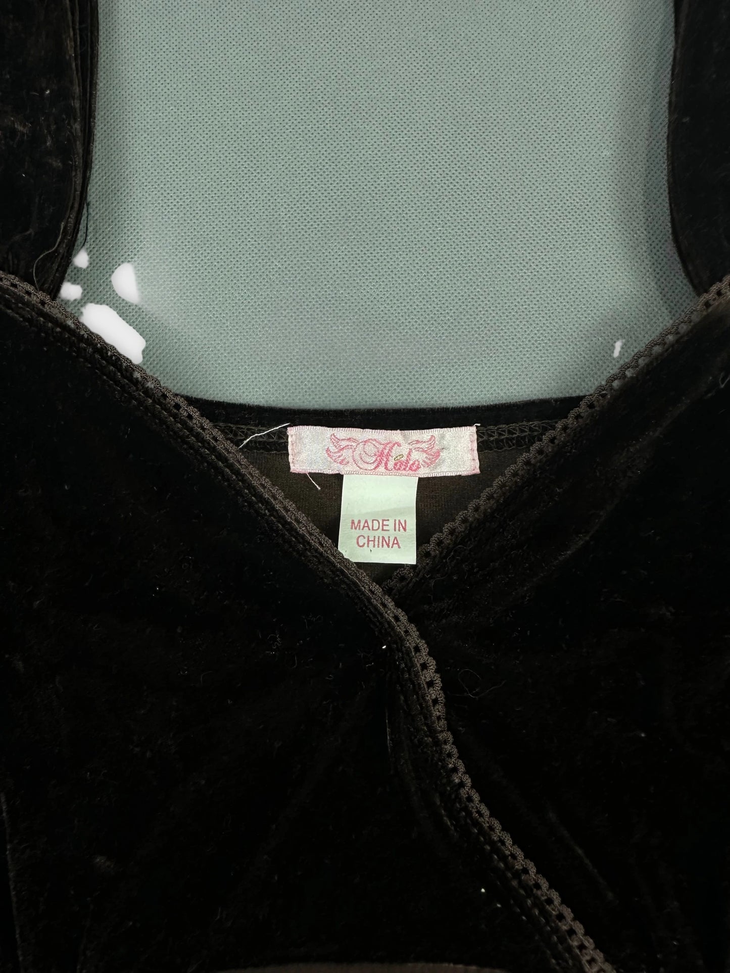 detail view of black upper body shorts featuring a lace trim and tag